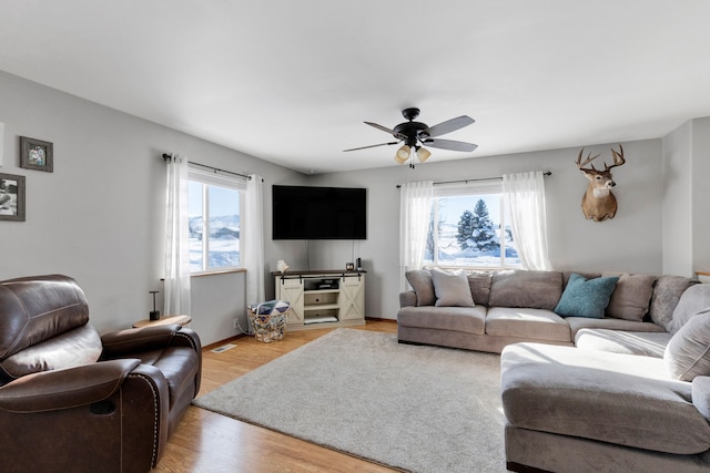 living room featuring plenty of natural light, light hardwood / wood-style floors, and ceiling fan