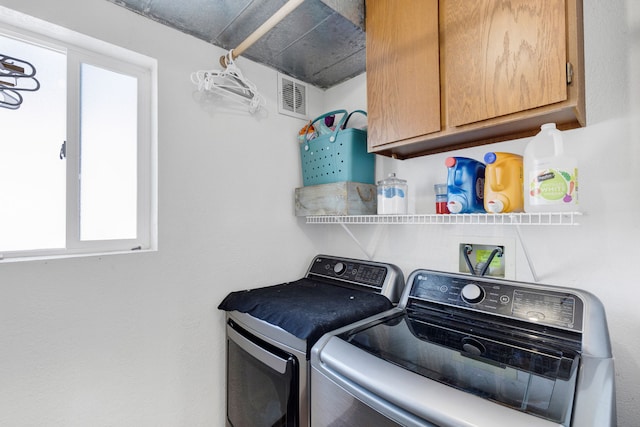 laundry area featuring cabinets and separate washer and dryer