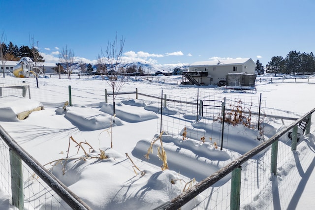 yard covered in snow with a mountain view