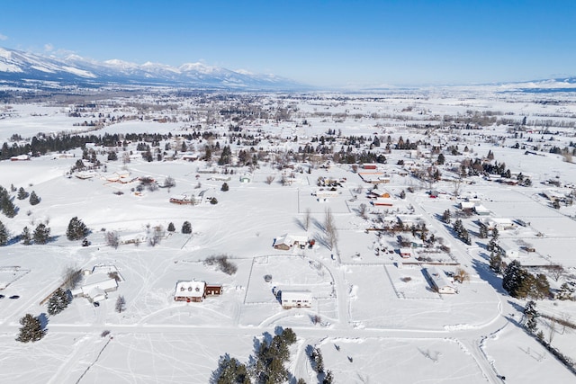 snowy aerial view featuring a mountain view