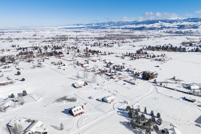 snowy aerial view featuring a mountain view