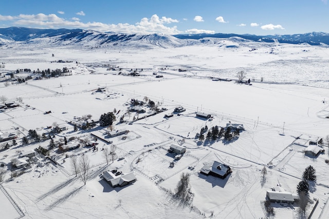 snowy aerial view with a mountain view