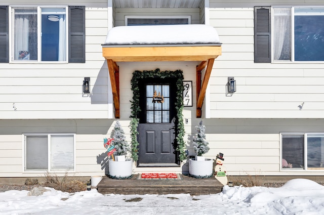 view of snow covered property entrance