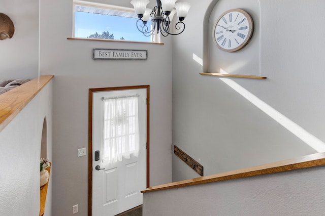 foyer featuring a wealth of natural light and a chandelier