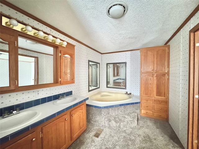 bathroom with crown molding, vanity, tiled bath, and a textured ceiling