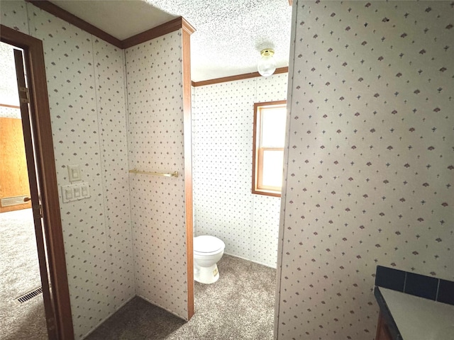 bathroom featuring vanity, ornamental molding, and toilet