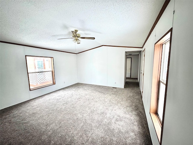 carpeted empty room featuring crown molding, ceiling fan, and a textured ceiling