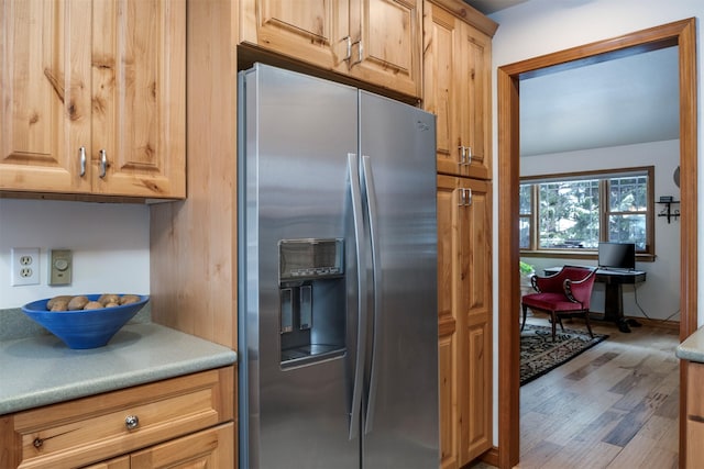 kitchen featuring stainless steel fridge with ice dispenser and hardwood / wood-style floors