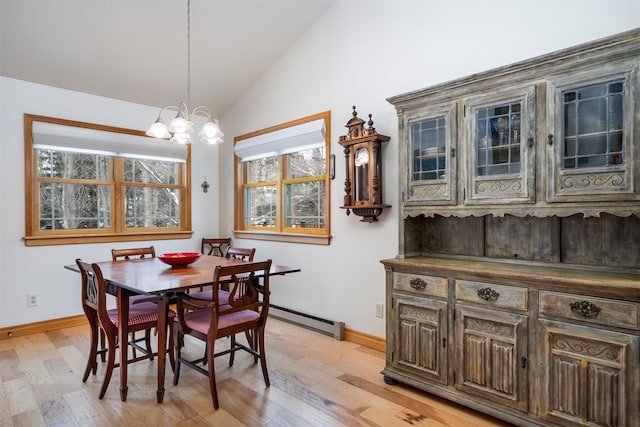 dining space featuring a baseboard radiator, lofted ceiling, light hardwood / wood-style floors, and a notable chandelier