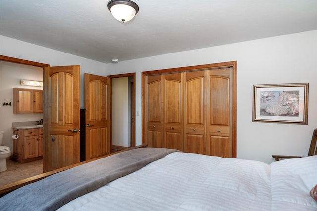 bedroom featuring connected bathroom and a closet