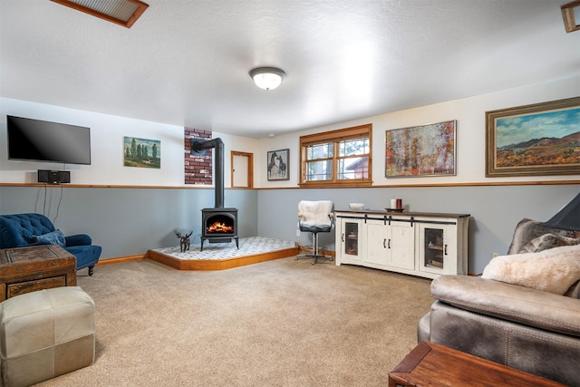 carpeted living room featuring a wood stove