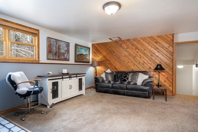 living room featuring carpet floors and wood walls