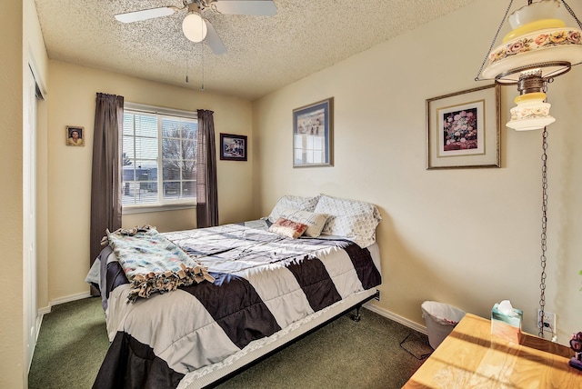 carpeted bedroom with ceiling fan and a textured ceiling