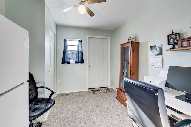 carpeted office with ceiling fan