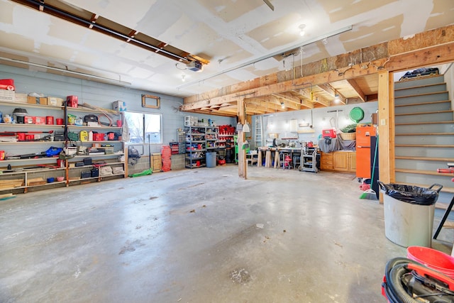 garage with a garage door opener and a workshop area