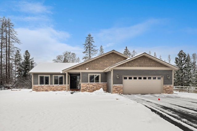 craftsman house with a garage and stone siding