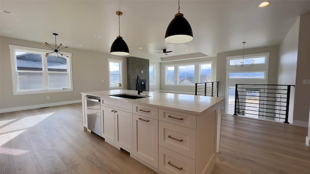7018 Max Dr, Missoula, MT 59803 - kitchen featuring dishwasher, a sink, a notable chandelier, and light wood-style flooring