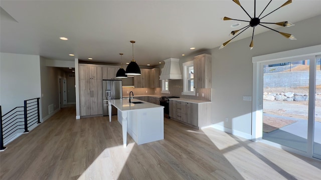 7018 Max Dr, Missoula, MT 59803 - kitchen featuring a wealth of natural light, premium range hood, range with gas cooktop, and stainless steel fridge with ice dispenser
