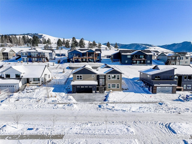 snowy aerial view featuring a mountain view