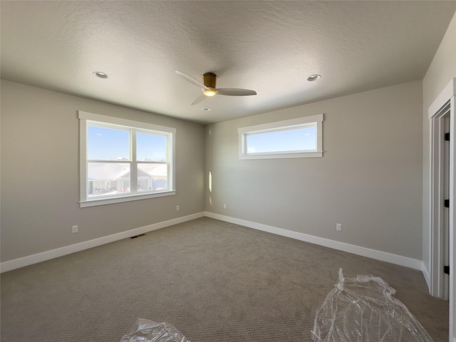 unfurnished bedroom with ceiling fan, carpet floors, and a textured ceiling