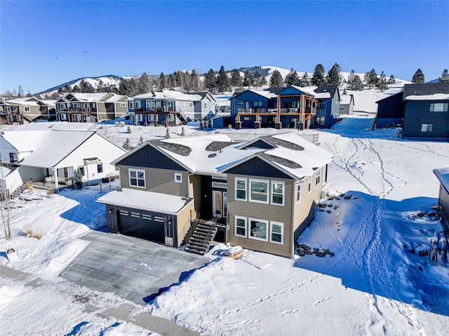 snowy aerial view featuring a mountain view