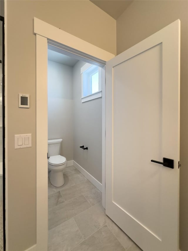7018 Max Dr, Missoula, MT 59803 - bathroom with marble finish floor, toilet, and baseboards