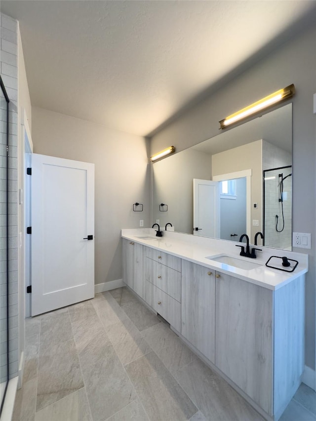 bathroom featuring vanity and a shower with shower door