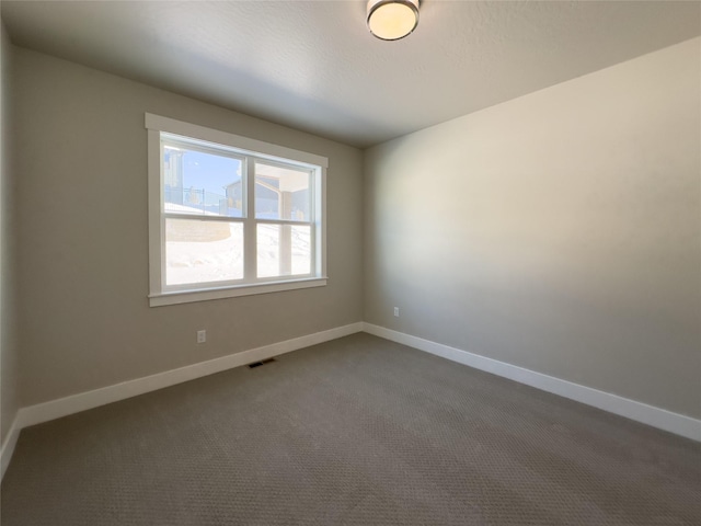 7018 Max Dr, Missoula, MT 59803 - empty room with baseboards, dark colored carpet, and visible vents