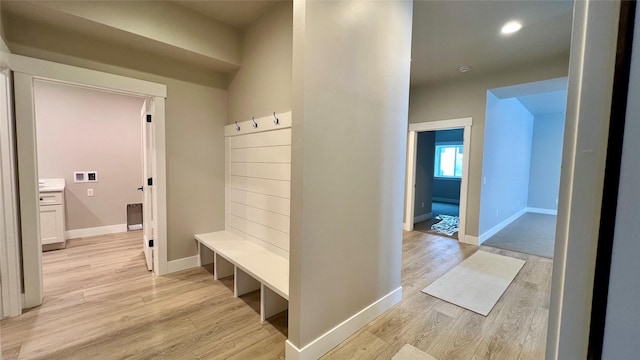 mudroom with light hardwood / wood-style flooring