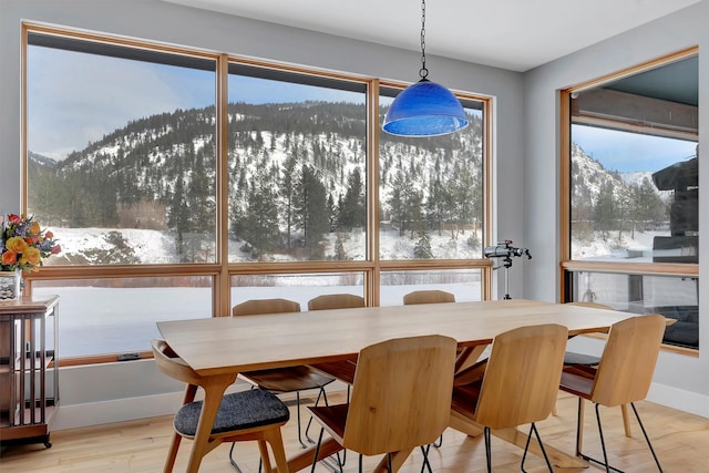 dining area with a mountain view and light wood-type flooring