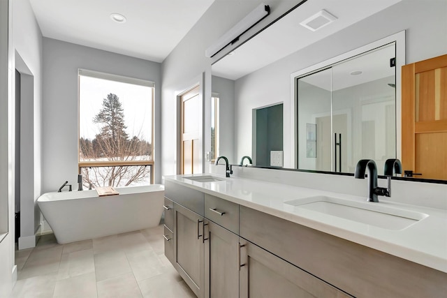 bathroom featuring vanity, a tub, and tile patterned floors