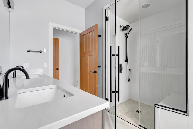 bathroom with vanity and a shower with door