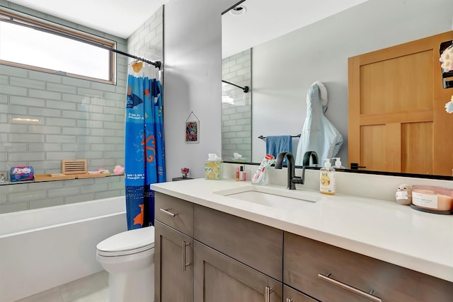 full bathroom featuring tile patterned floors, vanity, toilet, and shower / bath combo