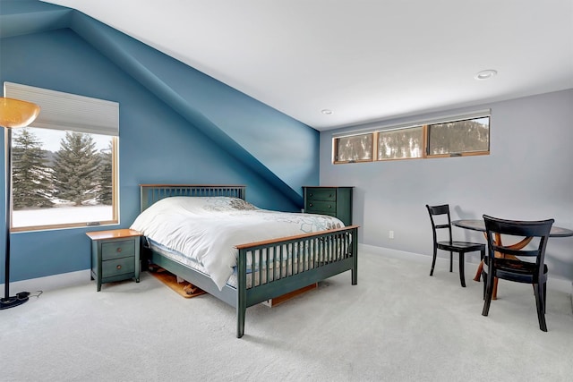 bedroom with multiple windows, lofted ceiling, and carpet floors