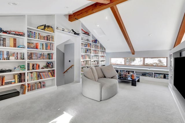 living area featuring lofted ceiling with beams, carpet flooring, and built in shelves