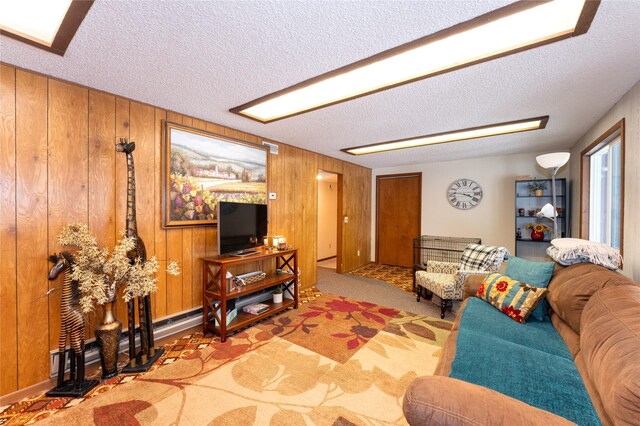 living room featuring carpet floors, wooden walls, and a textured ceiling