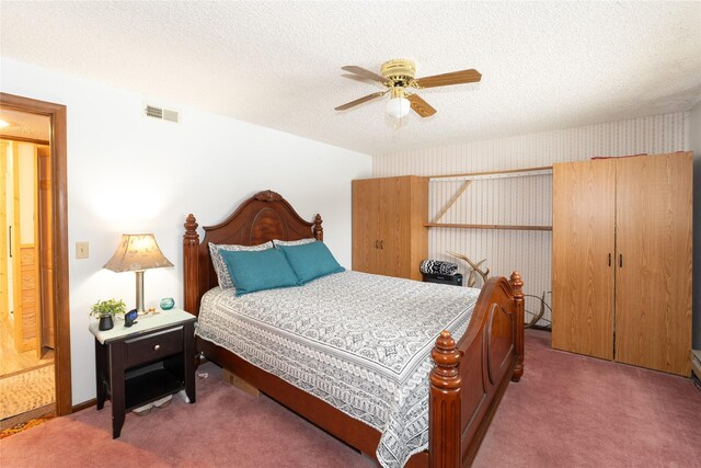 carpeted bedroom featuring a ceiling fan, visible vents, a textured ceiling, and wallpapered walls