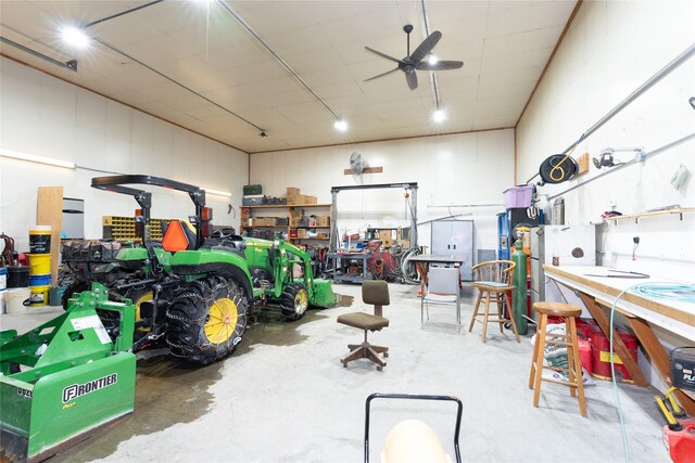 garage with ceiling fan and a workshop area