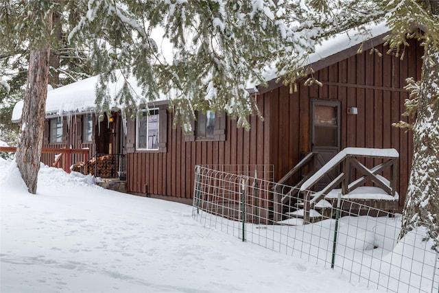 view of snowy exterior with board and batten siding