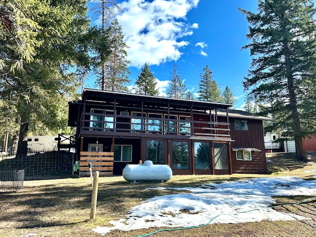 rear view of property featuring fence