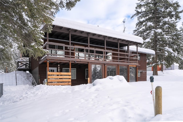 view of snow covered rear of property