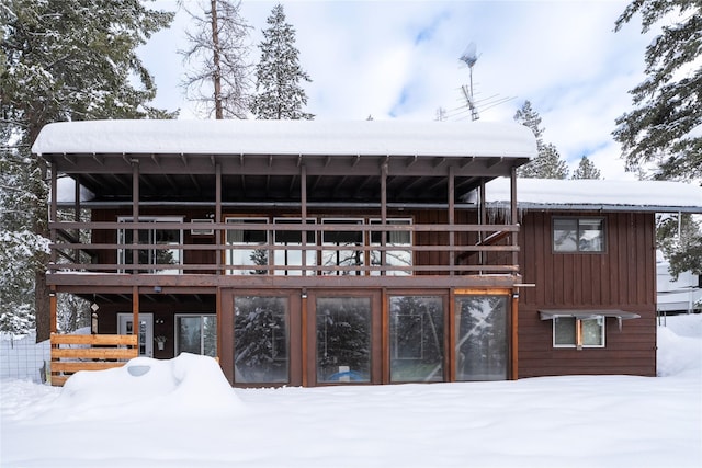 snow covered property featuring a deck