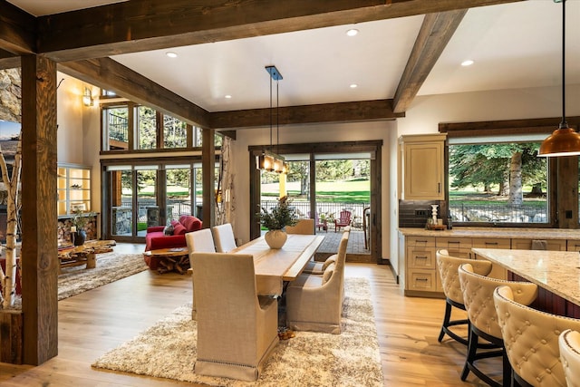 dining room with plenty of natural light, beam ceiling, and light hardwood / wood-style floors