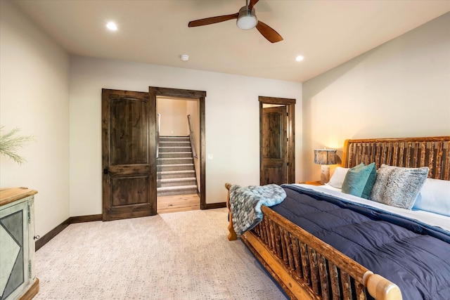 bedroom with light carpet and ceiling fan