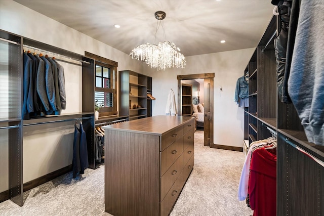 walk in closet featuring a chandelier and light carpet