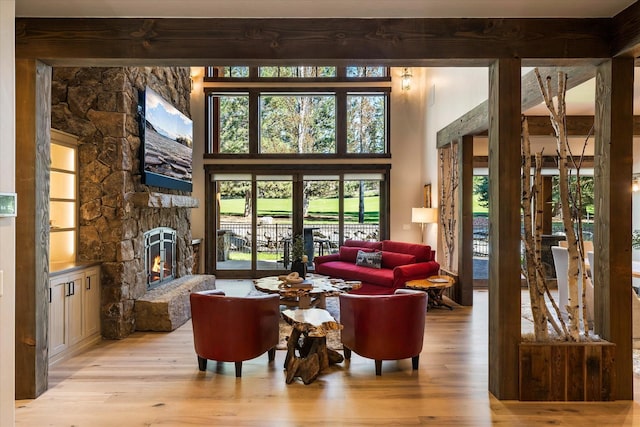 113 Levi Ct, Bigfork, MT 59911 - living area with wood finished floors and a stone fireplace