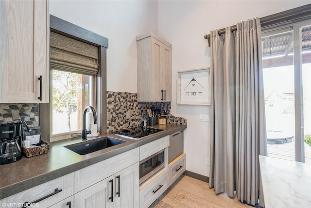 76 Rusty Iron Way, Eureka, MT 59917 - kitchen featuring a sink, decorative backsplash, and dark countertops