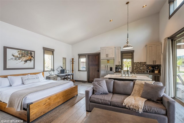 76 Rusty Iron Way, Eureka, MT 59917 - bedroom featuring built in refrigerator, light wood-style flooring, high vaulted ceiling, a sink, and recessed lighting