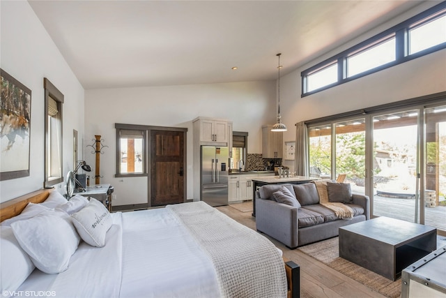 76 Rusty Iron Way, Eureka, MT 59917 - bedroom with stainless steel built in fridge, access to exterior, light wood-type flooring, a sink, and a towering ceiling
