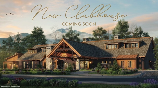 76 Rusty Iron Way, Eureka, MT 59917 - view of front of home with a chimney, stone siding, and a mountain view